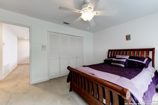 carpeted bedroom featuring ceiling fan and a closet