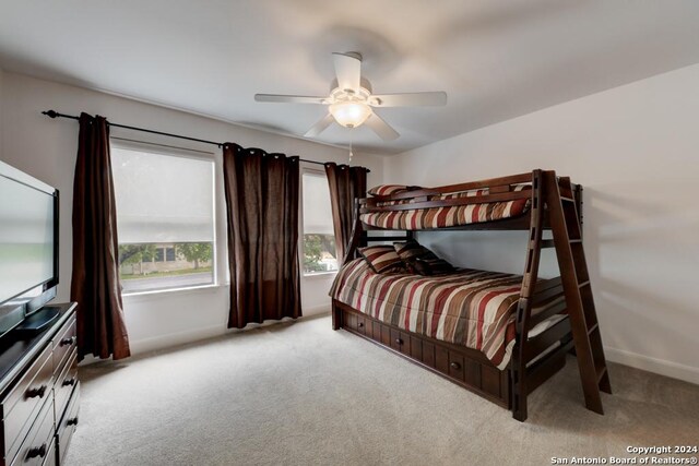 bedroom with light carpet and ceiling fan