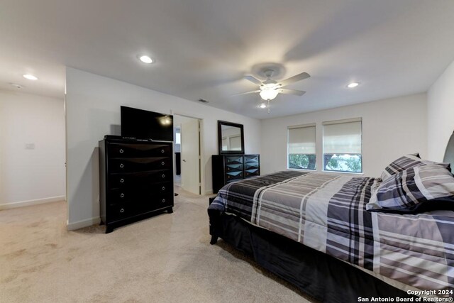 bedroom featuring ceiling fan and light carpet