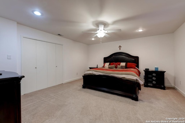 carpeted bedroom featuring ceiling fan and a closet