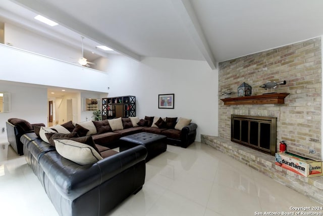 living room featuring ceiling fan, lofted ceiling with beams, a fireplace, and light tile patterned flooring