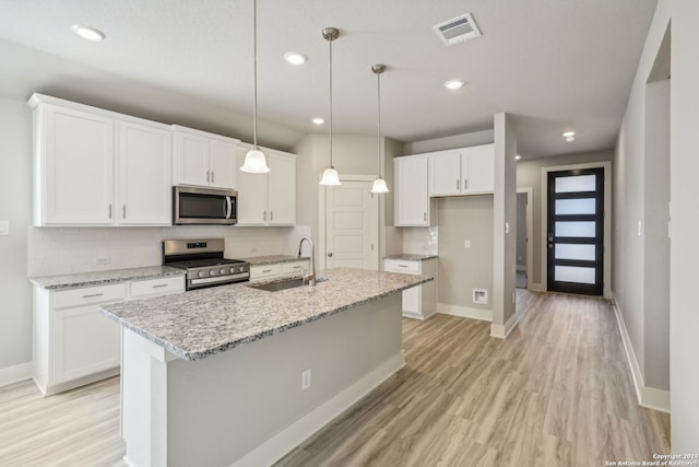 kitchen with sink, white cabinets, and stainless steel appliances