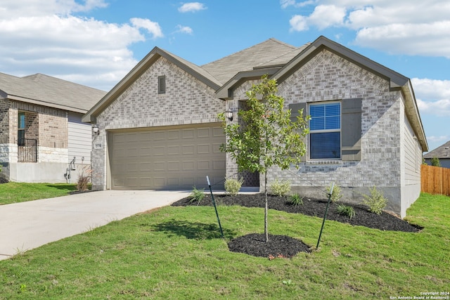 view of front of home with a garage and a front lawn