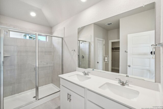 bathroom featuring walk in shower, vanity, and lofted ceiling