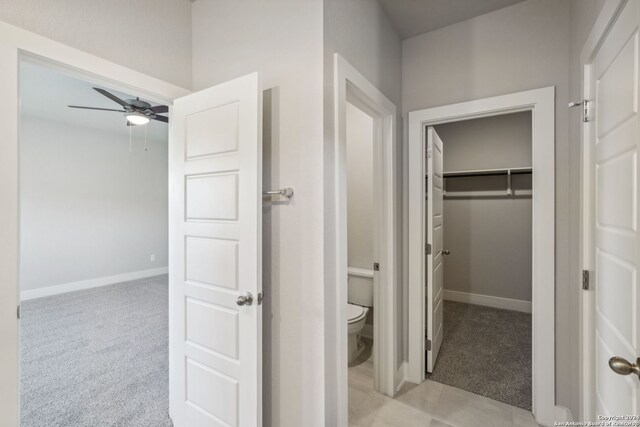 bathroom with ceiling fan and toilet