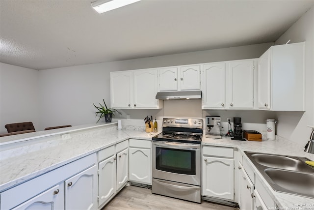 kitchen with white cabinetry, stainless steel electric range oven, sink, and light hardwood / wood-style flooring