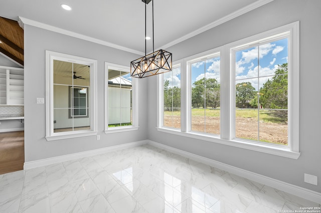 unfurnished dining area featuring ceiling fan with notable chandelier, light tile patterned floors, and ornamental molding