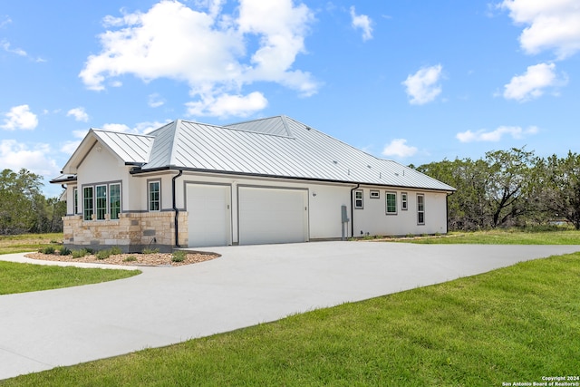 view of home's exterior with a garage and a lawn