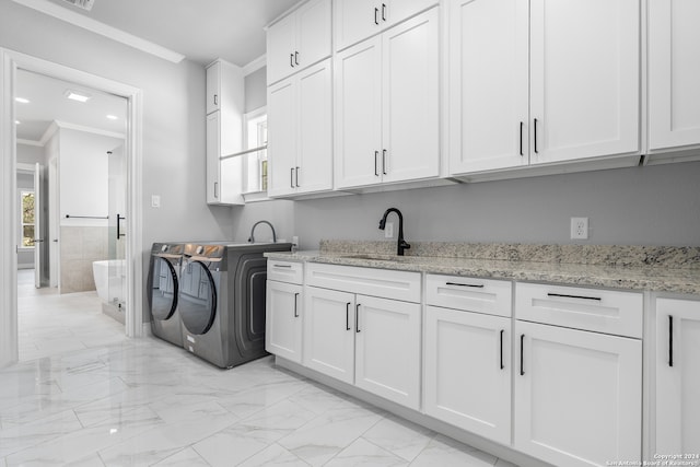 washroom with sink, cabinets, light tile patterned floors, crown molding, and separate washer and dryer