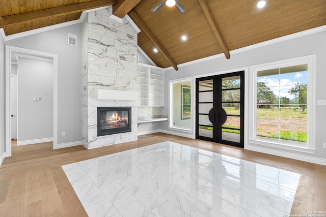 unfurnished living room with beam ceiling, french doors, wood ceiling, light hardwood / wood-style floors, and high vaulted ceiling