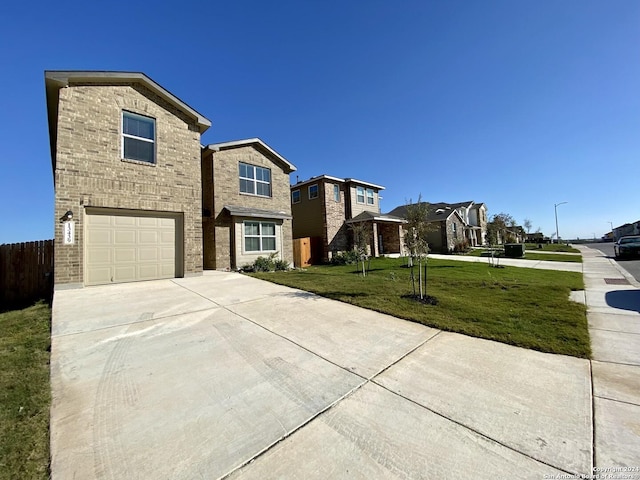 view of front of home with a garage and a front lawn