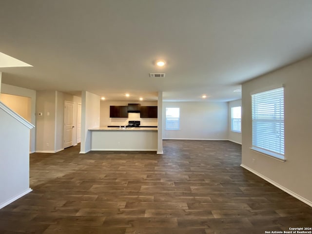 unfurnished living room with dark hardwood / wood-style flooring