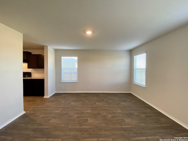 empty room with dark hardwood / wood-style flooring