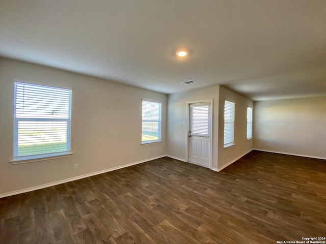 spare room with dark hardwood / wood-style floors