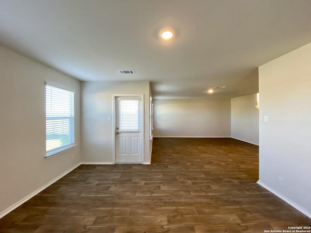 empty room with dark wood-type flooring