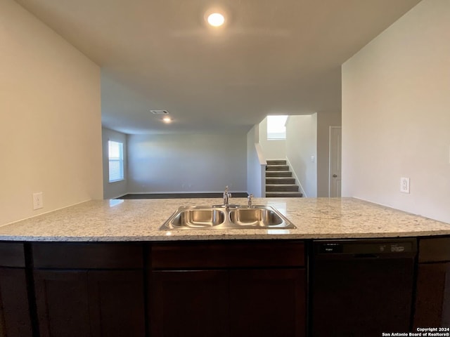 kitchen featuring dishwasher, dark brown cabinets, kitchen peninsula, and sink