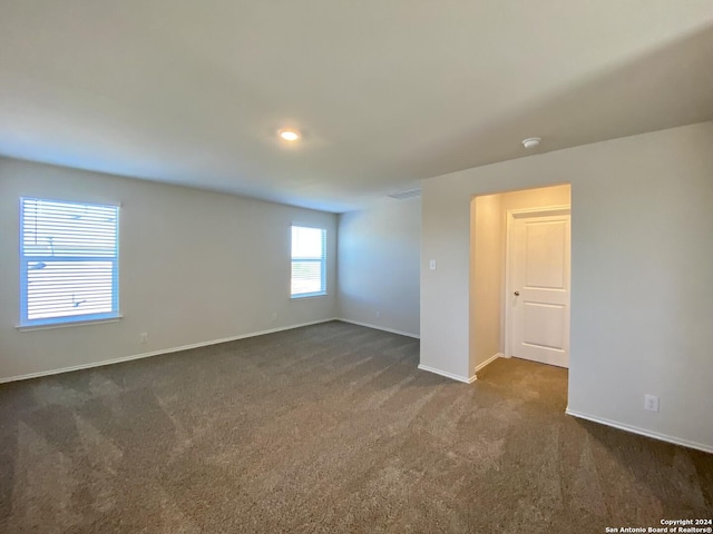 empty room featuring dark colored carpet