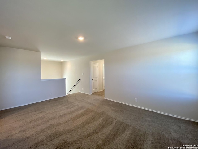 empty room with dark colored carpet