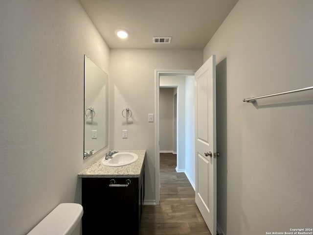 bathroom with hardwood / wood-style floors and vanity