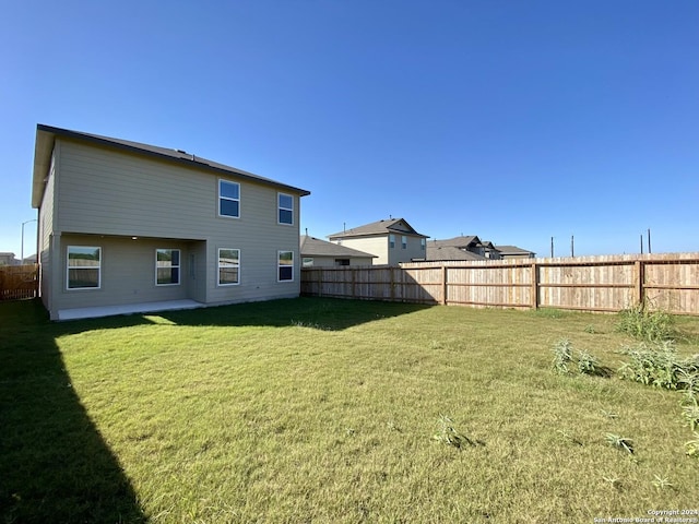 rear view of house featuring a lawn