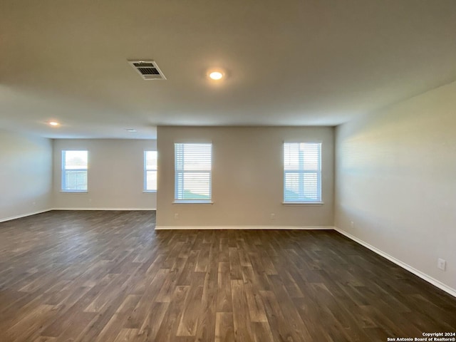 empty room with dark wood-type flooring