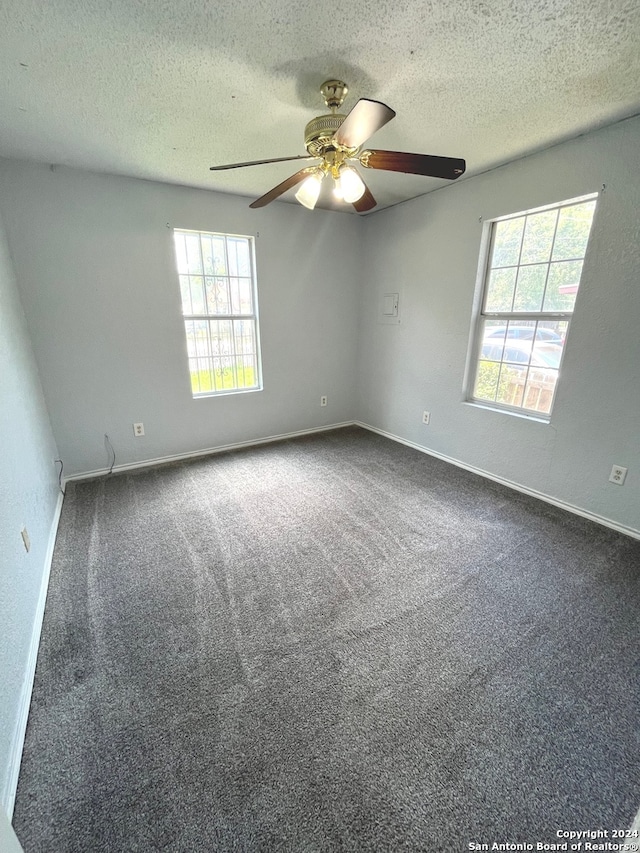 carpeted empty room featuring a textured ceiling and ceiling fan