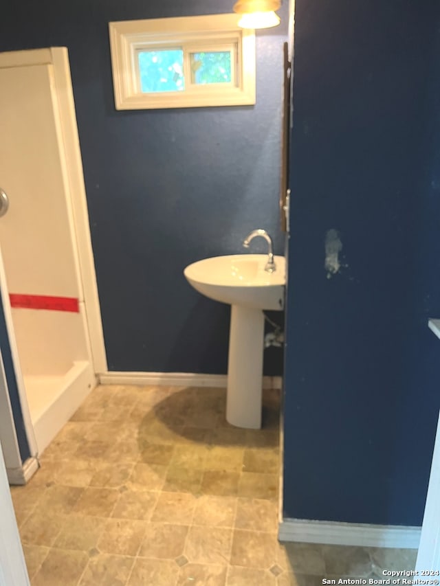 bathroom with tile patterned flooring and sink