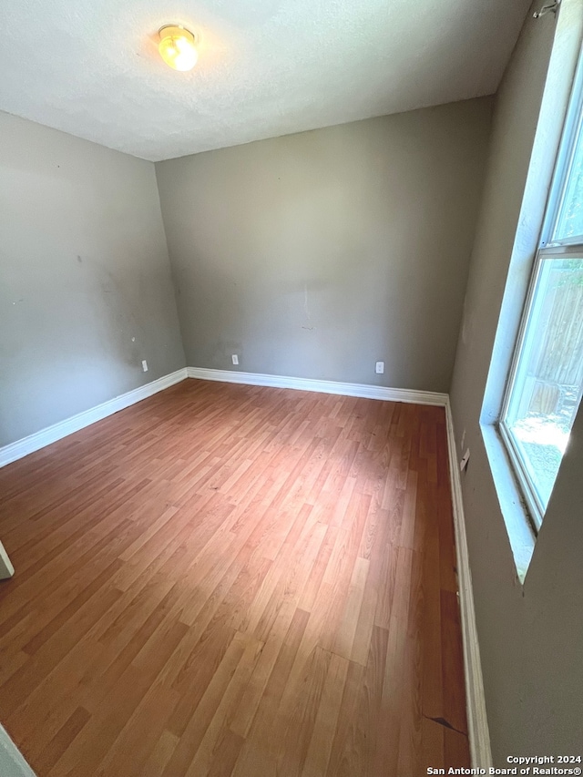 empty room featuring wood-type flooring