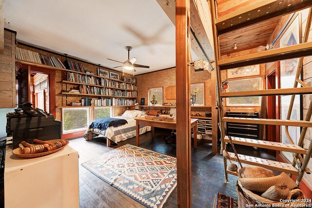 bedroom featuring ceiling fan, a closet, and dark hardwood / wood-style flooring