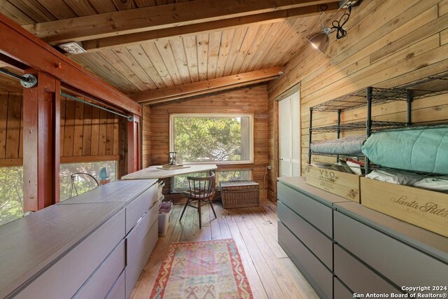 bathroom with wood walls, hardwood / wood-style floors, and vanity