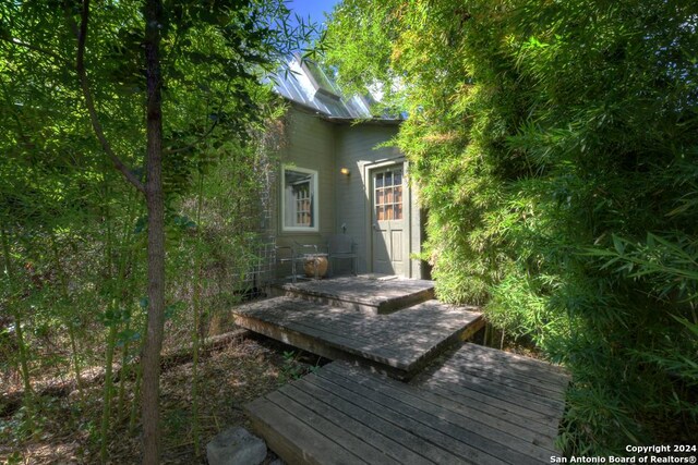 kitchen with washer / clothes dryer, dark hardwood / wood-style floors, and wooden walls