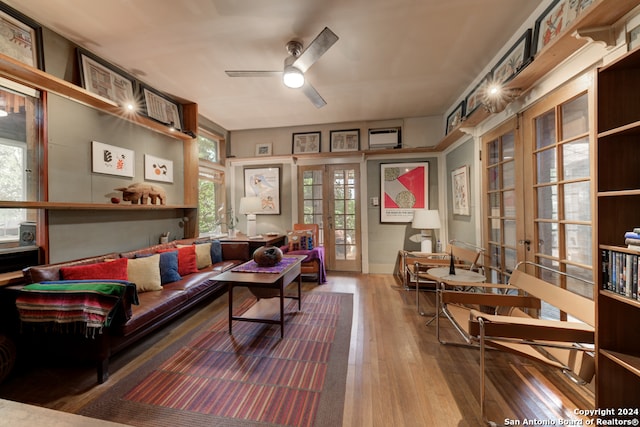 living room with ceiling fan, hardwood / wood-style floors, and french doors