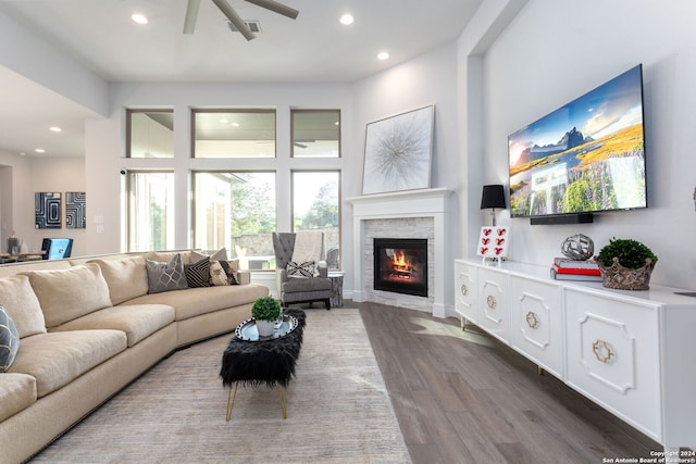 living room featuring a fireplace, dark hardwood / wood-style floors, and ceiling fan