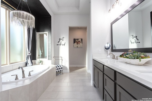 bathroom featuring tile patterned floors, vanity, plenty of natural light, and tiled tub