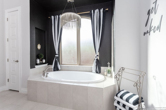 bathroom featuring tile patterned flooring and a relaxing tiled tub