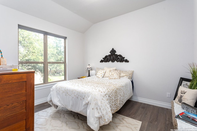 bedroom featuring dark wood-type flooring and lofted ceiling