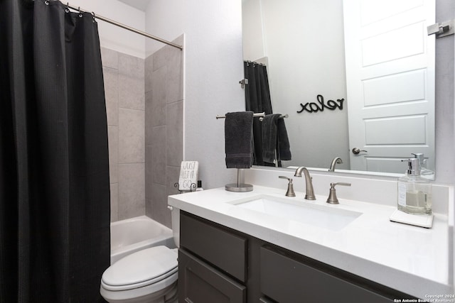 full bathroom featuring shower / tub combo with curtain, vanity, and toilet