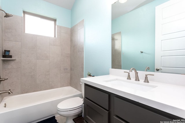 full bathroom featuring vanity, toilet, and tiled shower / bath