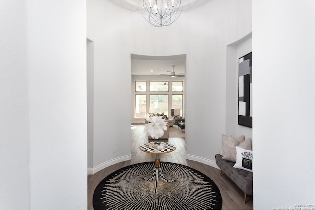 hall featuring a chandelier and hardwood / wood-style floors