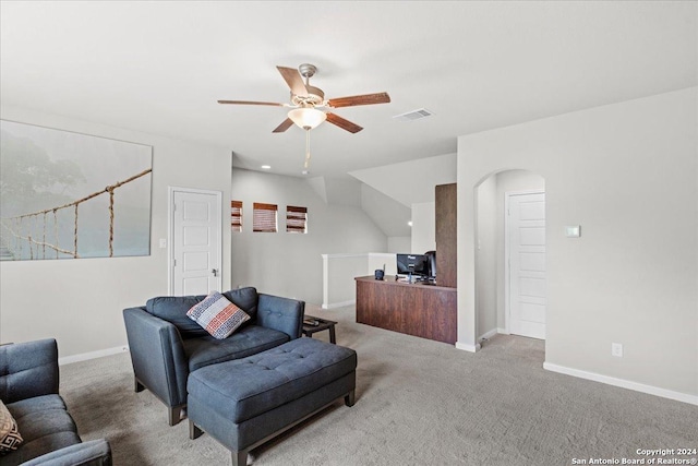 living room featuring ceiling fan and carpet