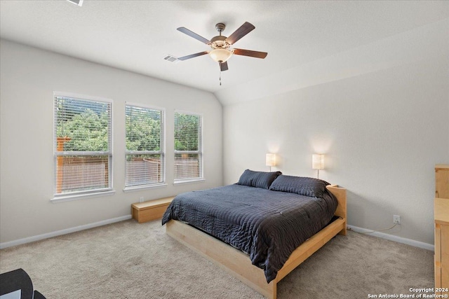 bedroom with light carpet, vaulted ceiling, and ceiling fan