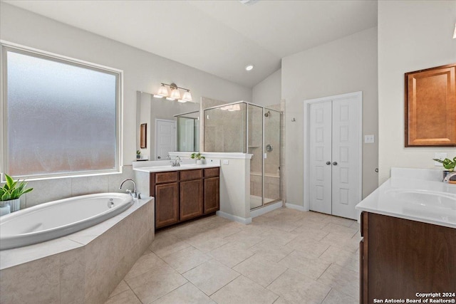 bathroom featuring a healthy amount of sunlight, vanity, independent shower and bath, and tile patterned floors