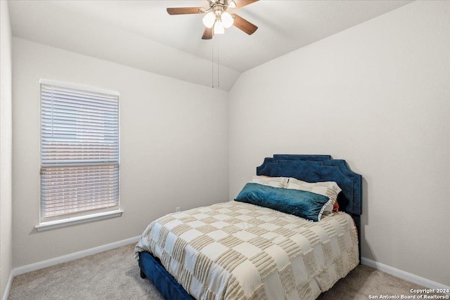 bedroom featuring vaulted ceiling, ceiling fan, and carpet flooring