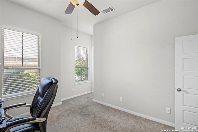 carpeted office space featuring ceiling fan