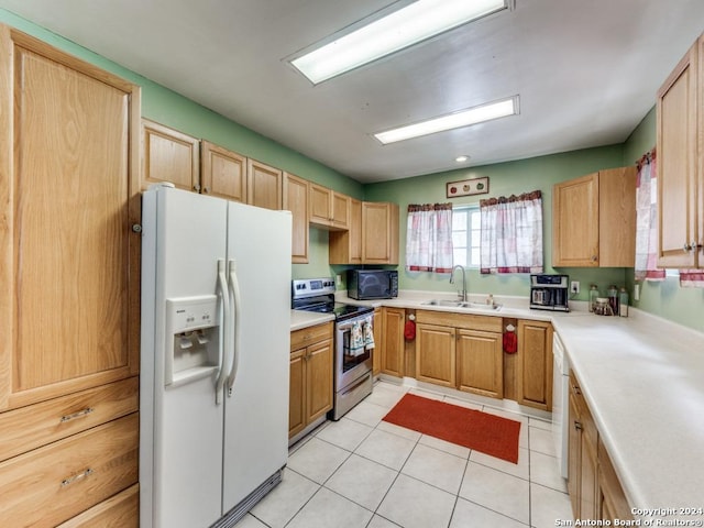 kitchen with light countertops, light brown cabinets, a sink, light tile patterned flooring, and white appliances