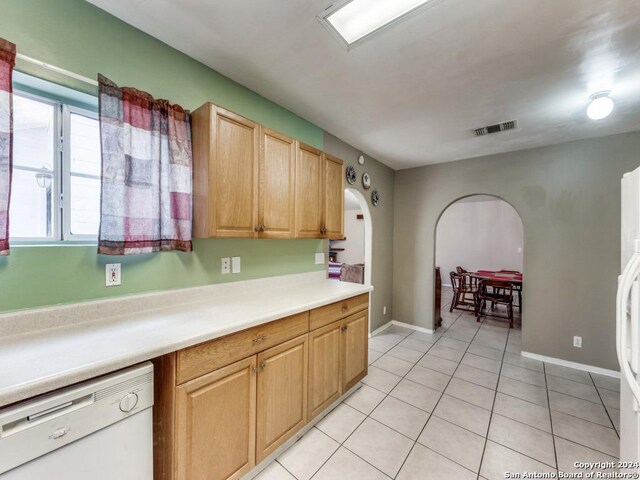 kitchen with white dishwasher and light tile patterned floors