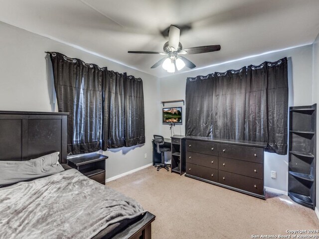 bedroom featuring light carpet and ceiling fan