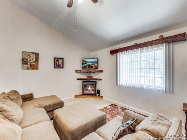 tiled living room featuring high vaulted ceiling and ceiling fan