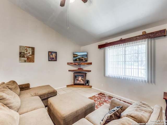 living room with lofted ceiling, light tile patterned flooring, a ceiling fan, and baseboards