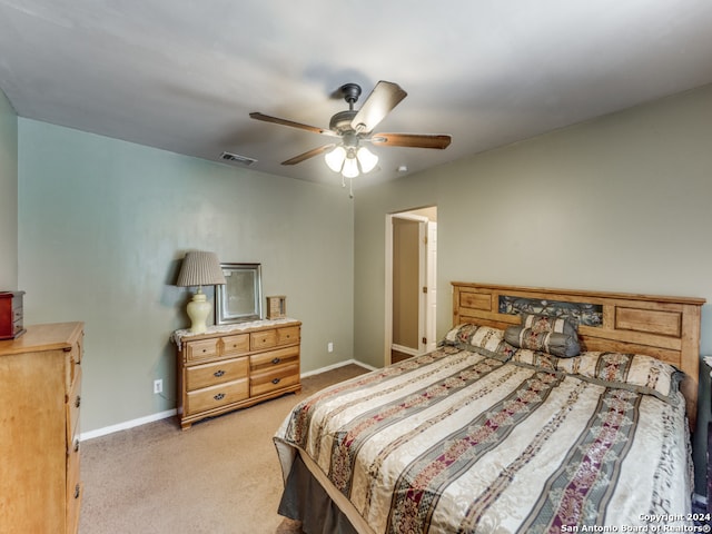 bedroom with ceiling fan and light colored carpet